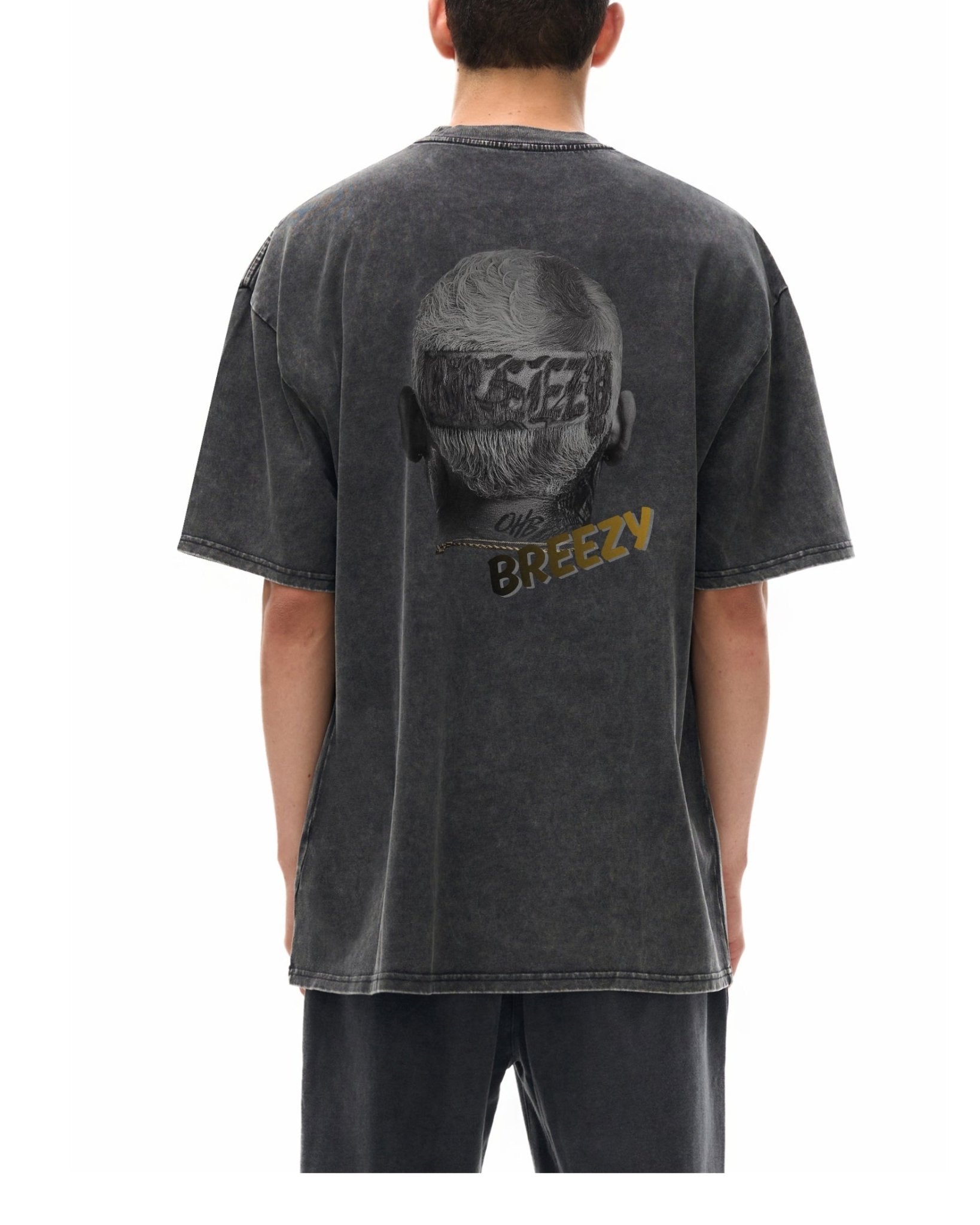 man wearing a black t-shirt with a graphic design of chris brown on the back, standing against a white background.