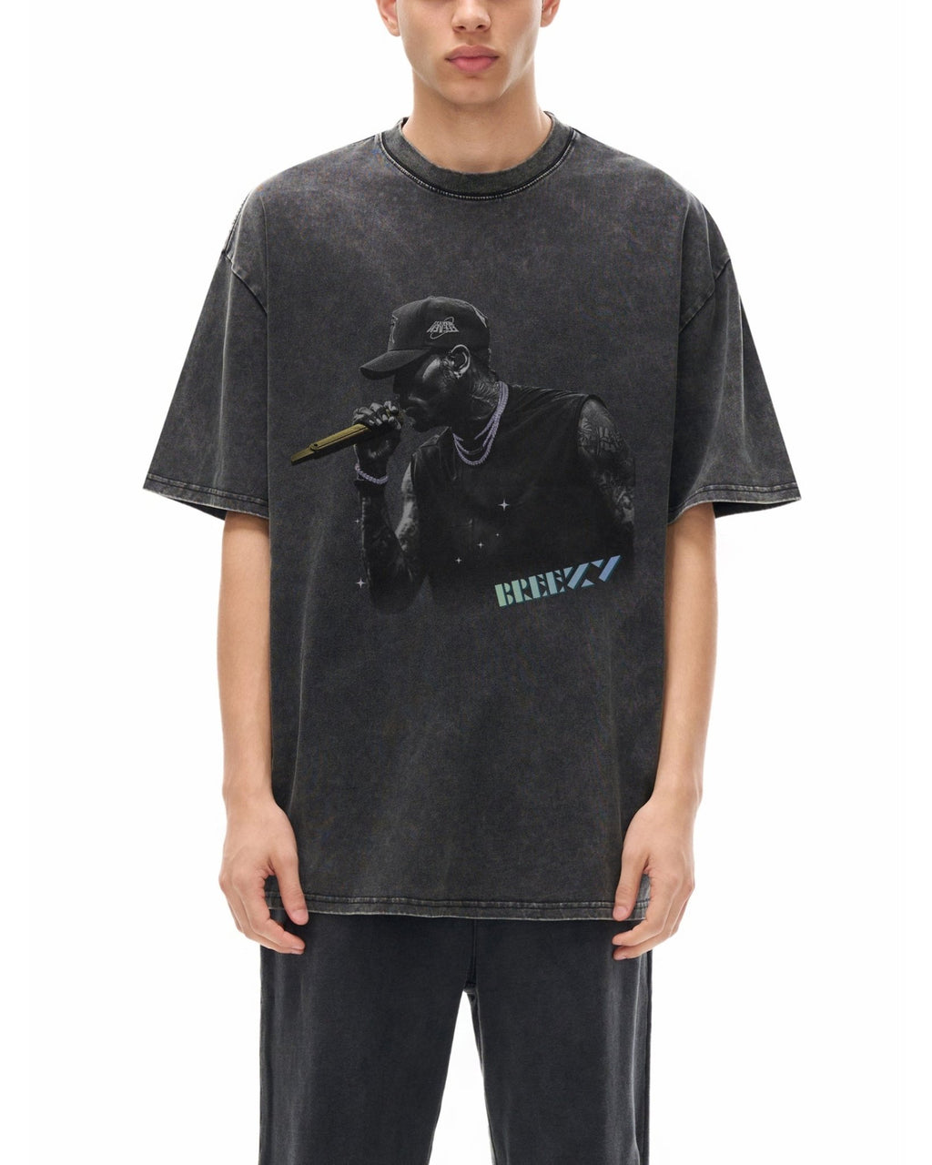 Person wearing a black t-shirt with a graphic design on a white background