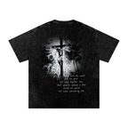 Back of a black snow-washed Christian T-shirt featuring a black-and-white crucifixion scene of Jesus on the cross with the John 3:16 Bible verse below.