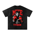 Black snow-washed oversized graphic T-shirt featuring a black-and-white portrait of Mike Tyson in a boxing stance, wearing bright red gloves, with bold red MIKE lettering above and TYSON below.