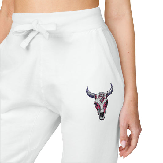 close up view of woman wearing White women's jogger pants with a bull skull design on a white background