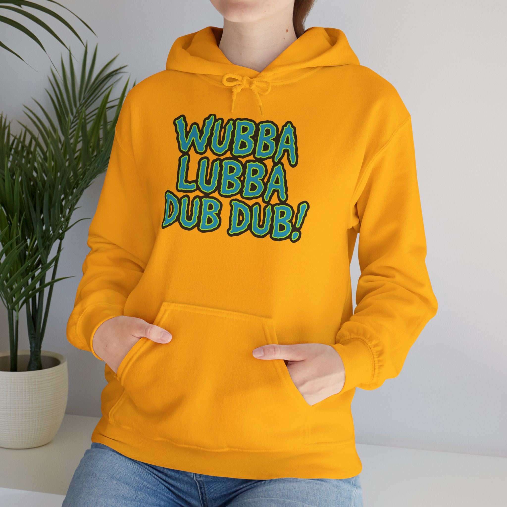 Person wearing a yellow hoodie with 'Wubba Lubba Dub Dub!' text, standing against a neutral background.
