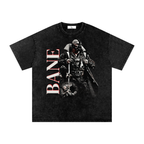 Washed-black oversized Bane T-shirt featuring the masked Dark Knight villain in black armor beside large vertical BANE lettering.