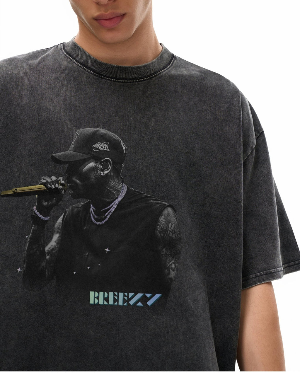 close up of man wearing a black t-shirt with a graphic of a breezy holding a microphone and the word 'BREEZY'.