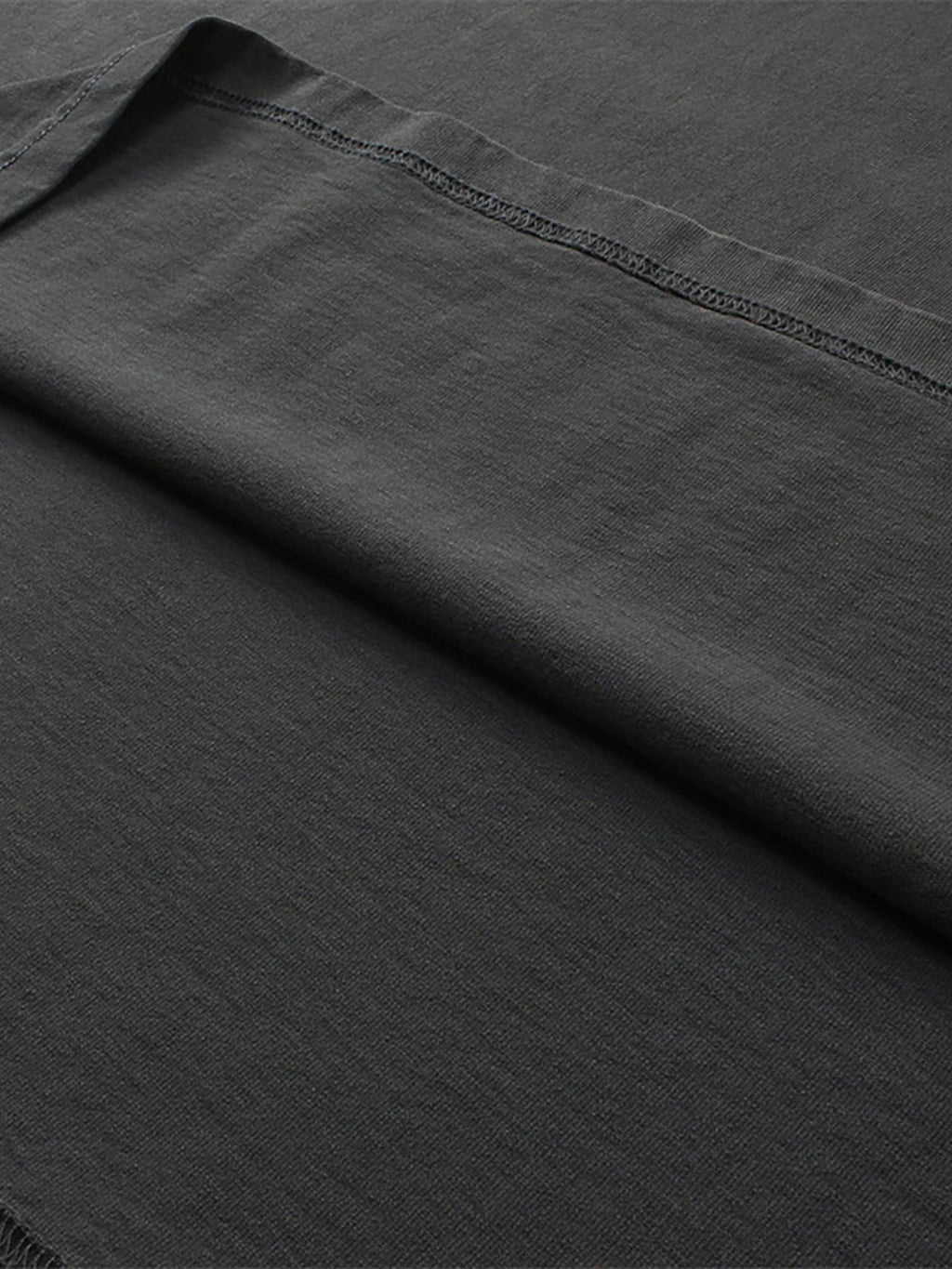 close up image of pchillthredz black tee fabric thread lines and details