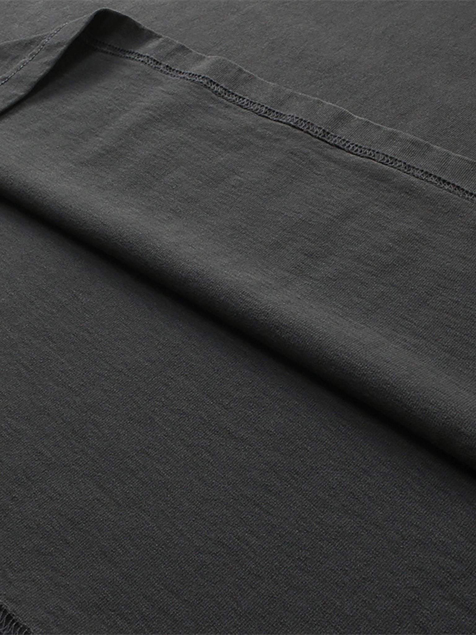close up image of pchillthredz black tee fabric thread lines and details