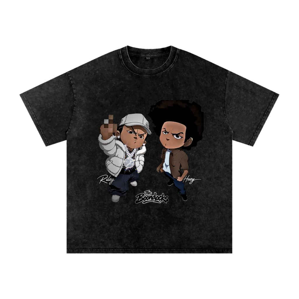 Black snow-washed The Boondocks graphic tee featuring Riley in a white puffer jacket and Huey standing beside him with The Boondocks logo below.