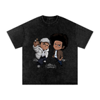 Black snow-washed The Boondocks graphic tee featuring Riley in a white puffer jacket and Huey standing beside him with The Boondocks logo below.
