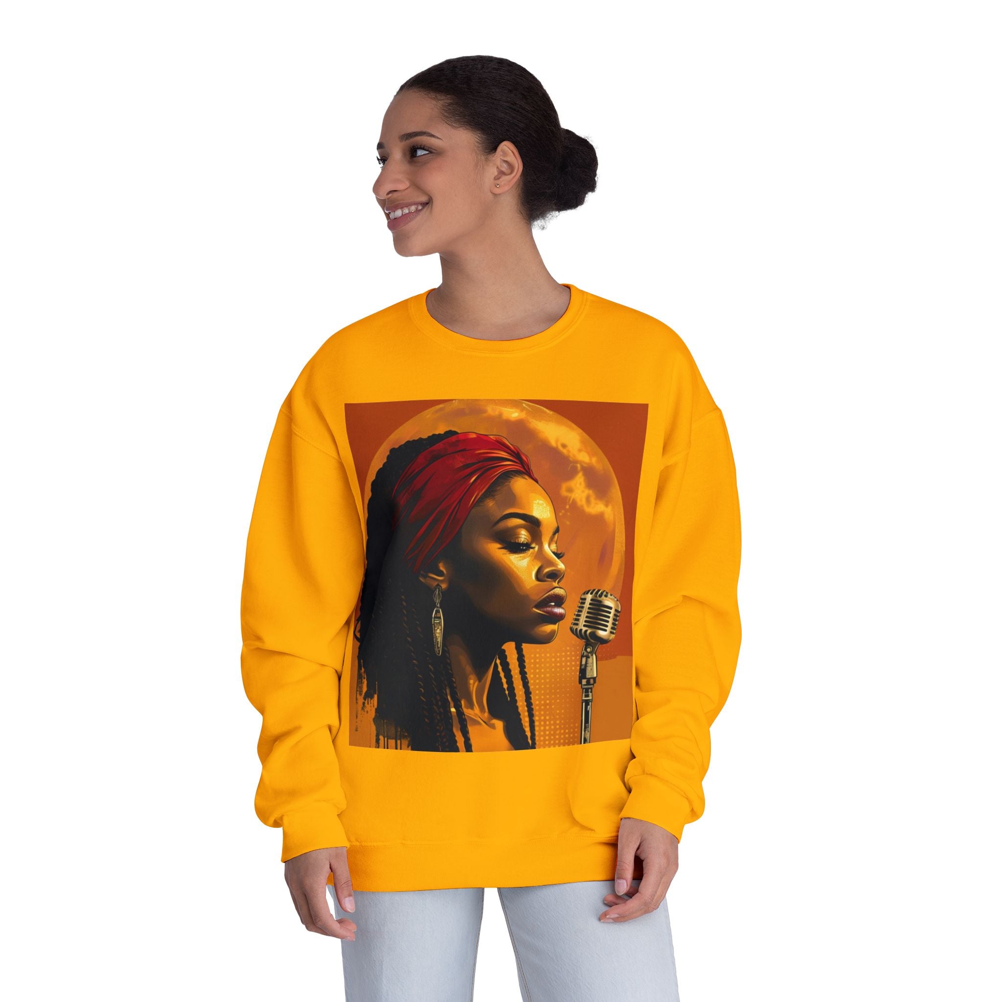 Woman wearing a gold sweatshirt with a graphic design of a woman and microphone