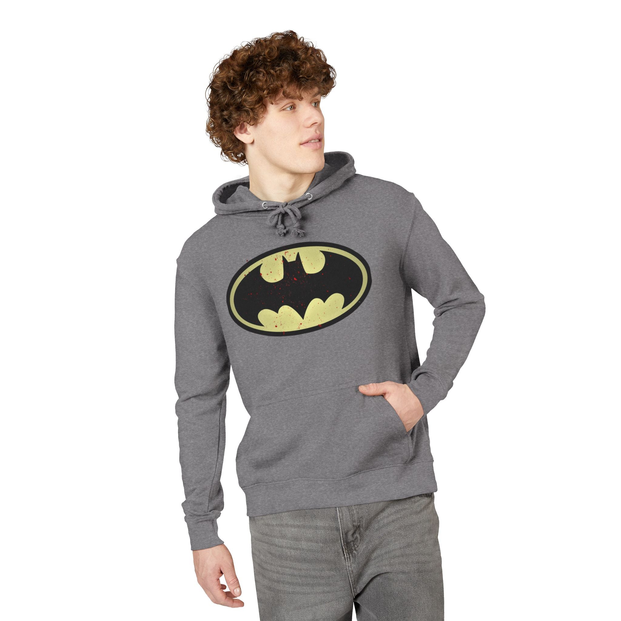 man wearing a graphite heather hoodie with a Batman logo in front of it