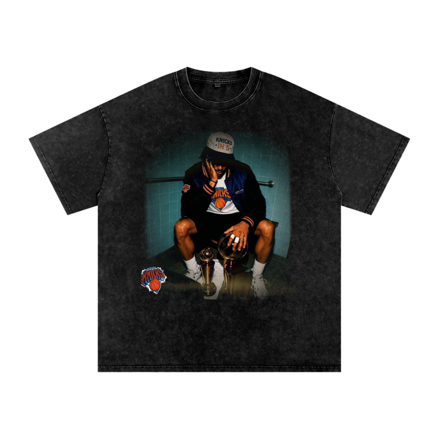 Front view of a washed-black Jalen Brunson T-shirt showing Brunson seated beside two championship trophies.