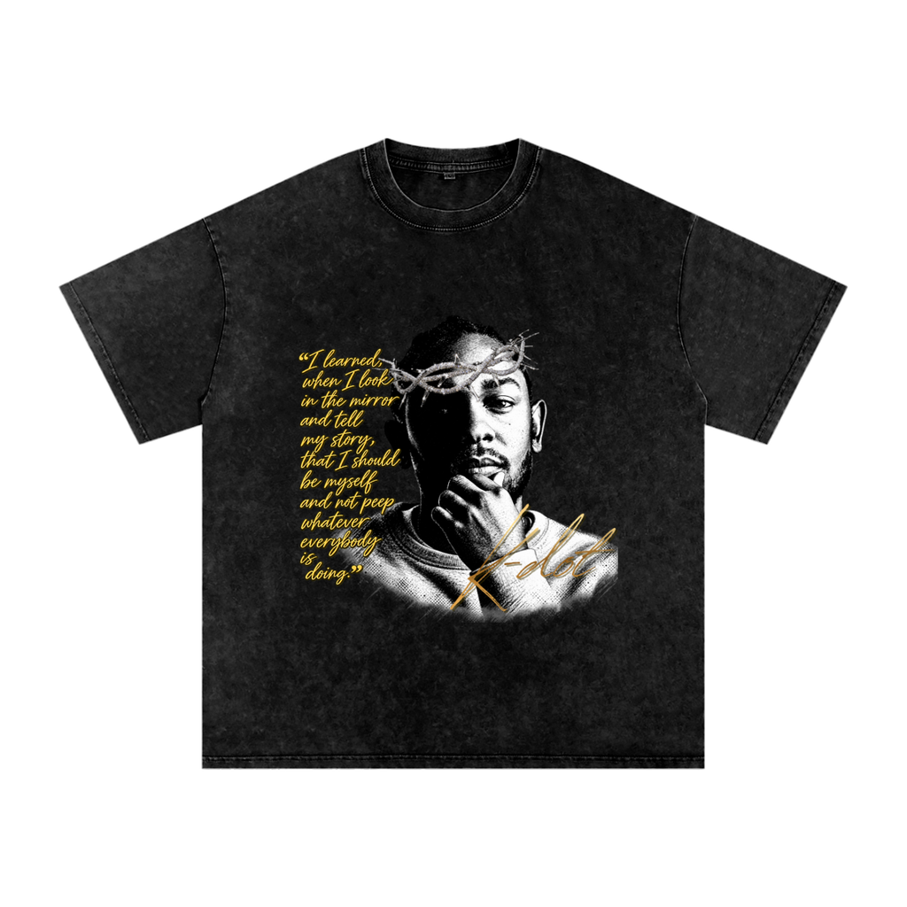 Black snow-washed oversized graphic T-shirt featuring a black-and-white Kendrick Lamar portrait with crown of thorns, gold motivational quote and K-Dot signature.