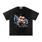 Washed-black oversized Lionel Messi T-shirt featuring multiple Argentina soccer portraits in a blue-and-white collage.
