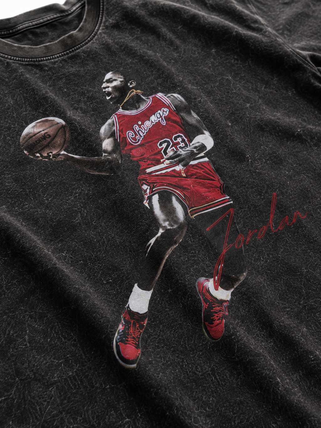 Close up Michael Jordan 23 dunking graphic printed on black snow washed t-shirt fabric with red uniform and Jordan signature