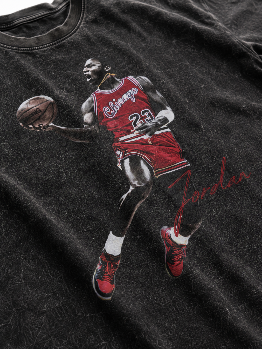 Close up Michael Jordan 23 dunking graphic printed on black snow washed t-shirt fabric with red uniform and Jordan signature