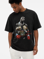 Model wearing black snow-washed Mike Tyson graphic t-shirt featuring championship belts and red boxing gloves