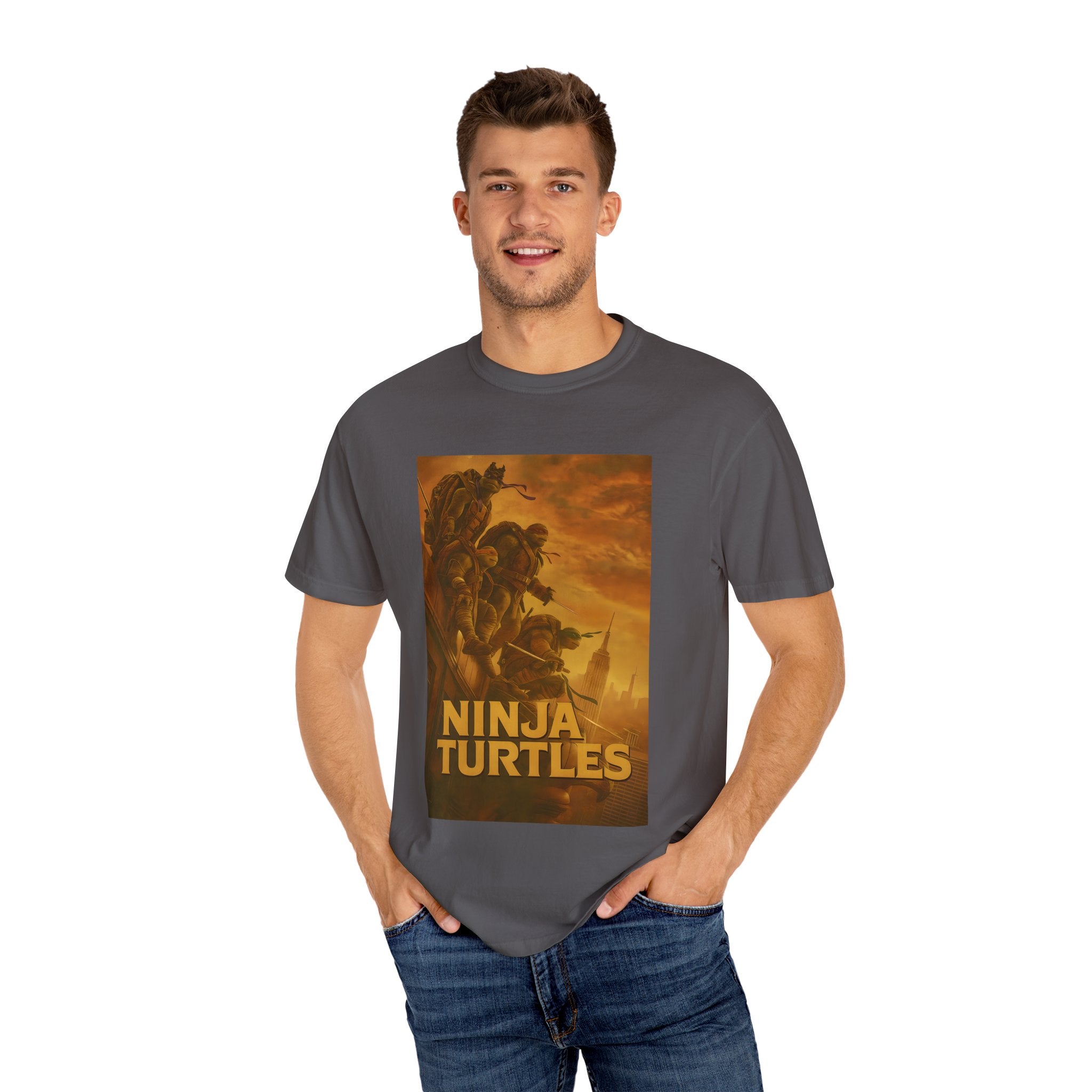 Man wearing a gray t-shirt with 'Ninja Turtles' graphic design on a white background