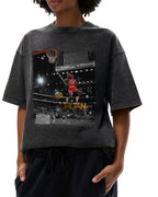 Person wearing a black vintage snowwashed t-shirt with a graphic of a michael jordan dunking