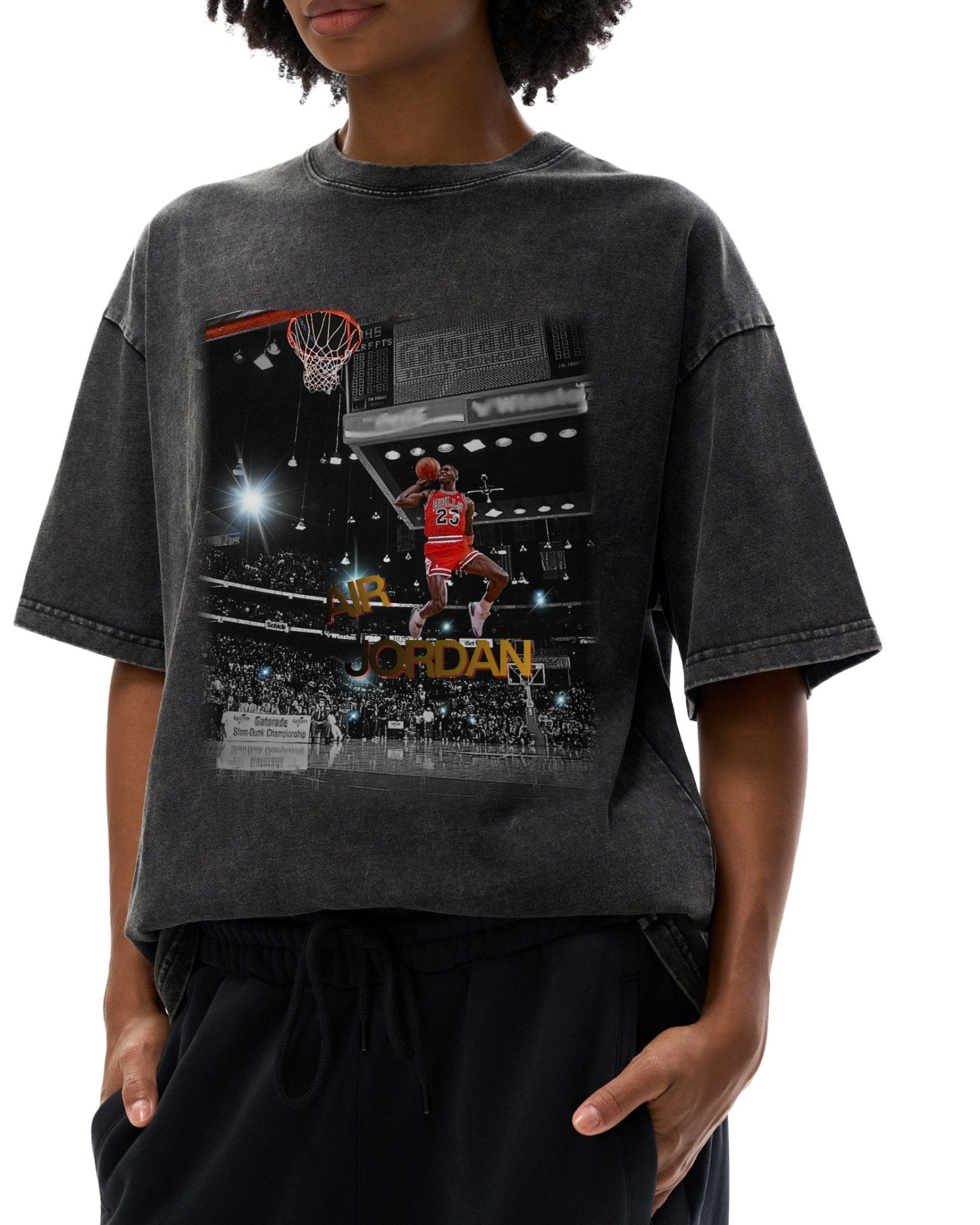 Person wearing a black t-shirt with a graphic of a basketball player dunking a hoop.