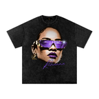 Washed-black oversized Rihanna T-shirt featuring a large portrait with purple sunglasses, matching lipstick and purple script.