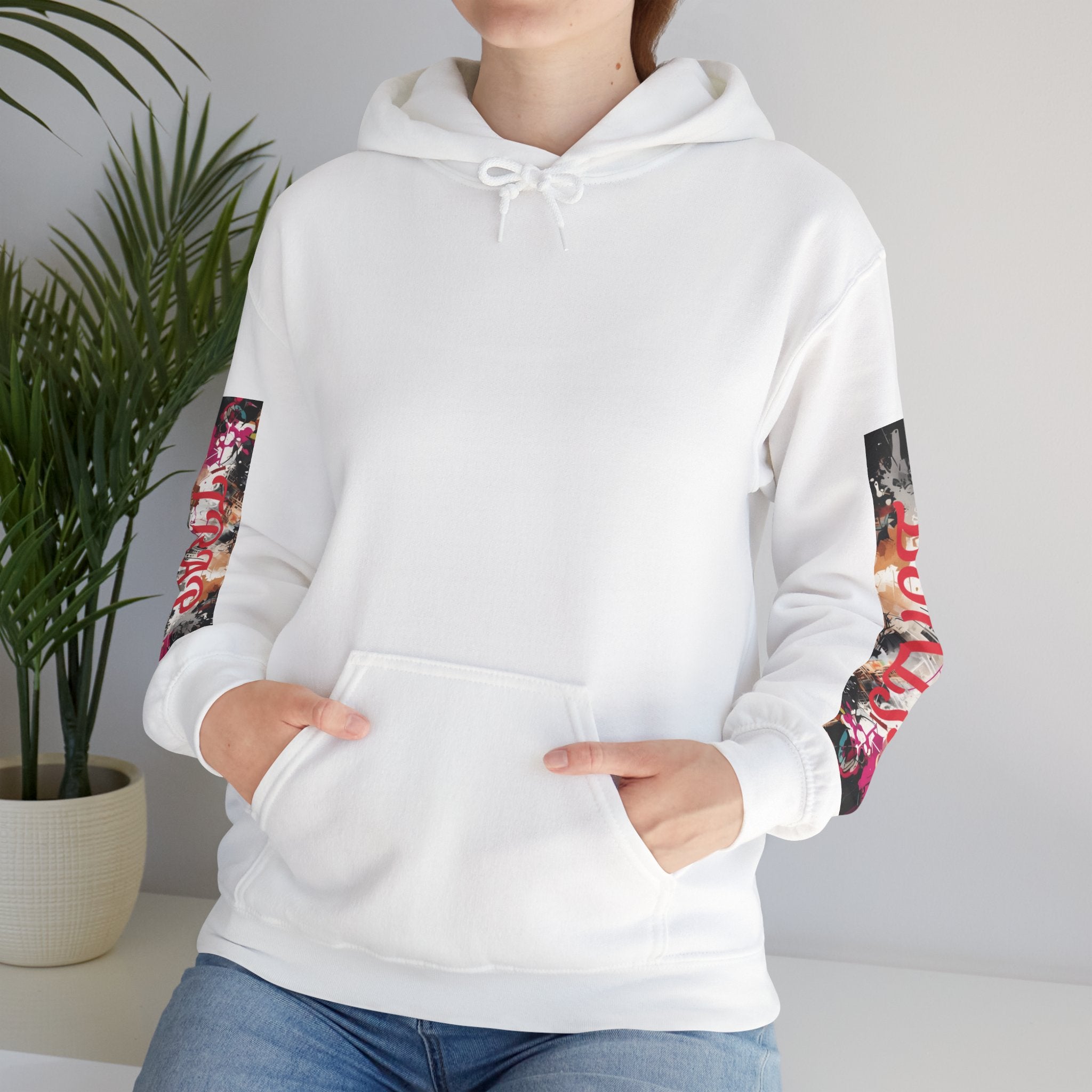 White graphic hoodie with colorful arm designs worn by a woman, against a neutral background.