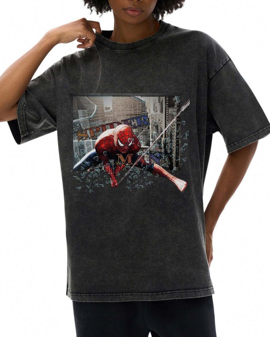 Person wearing a black t-shirt with a graphic design of a superhero character and text.