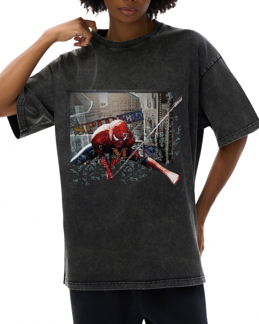 Person wearing a black t-shirt with a graphic design of a superhero character and text.